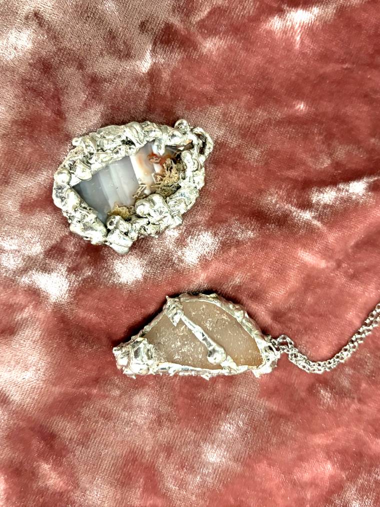 Handmade stone pendants on velvet made at a Hermara Creatives jewelry class in Cleveland