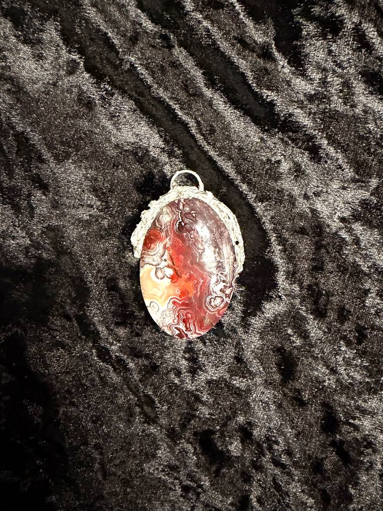 Rose quartz and mookaite jasper pendants made by first time students at a jewelry class