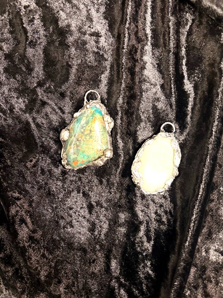 Turquoise and pale green stone pendants made by beginners at a Cleveland jewelry class
