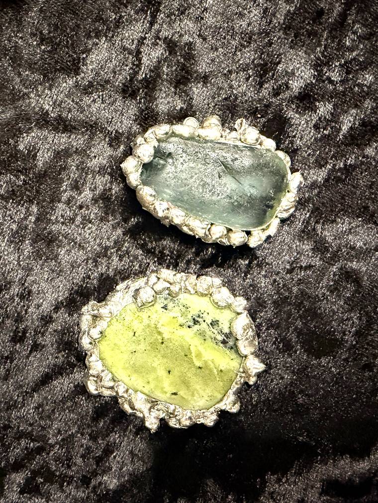 Two soldered stone pendants with beaded silver bezels made at a jewelry making workshop