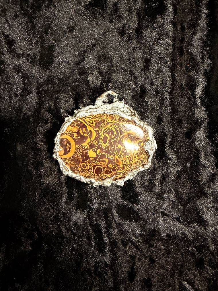 Fossil jasper pendant in a hand soldered silver setting made at a Cleveland craft workshop