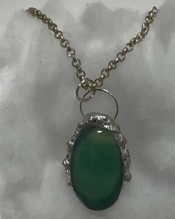Green glass cabochon pendant in a hand soldered setting made in Northeast Ohio